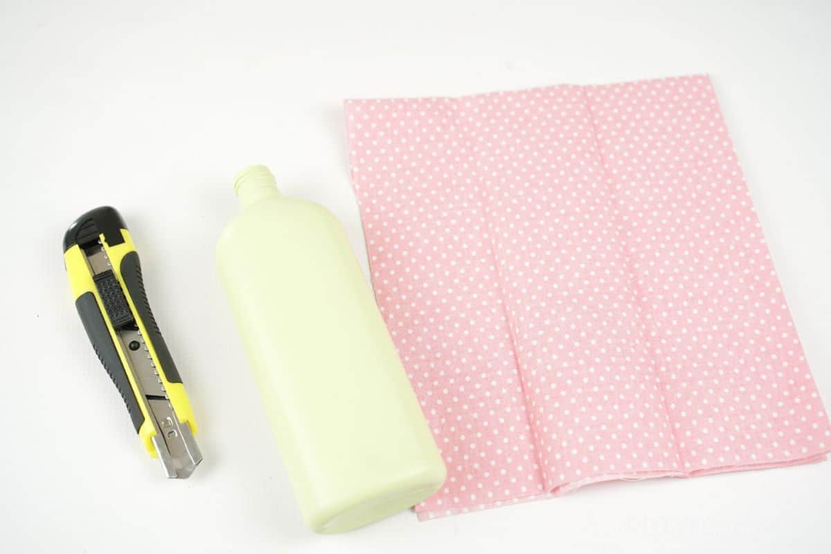 empty bottle pink fabric and craft knife
