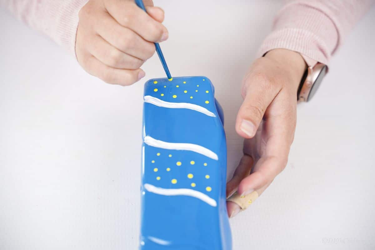 hand painted white dots on blue painted bottle