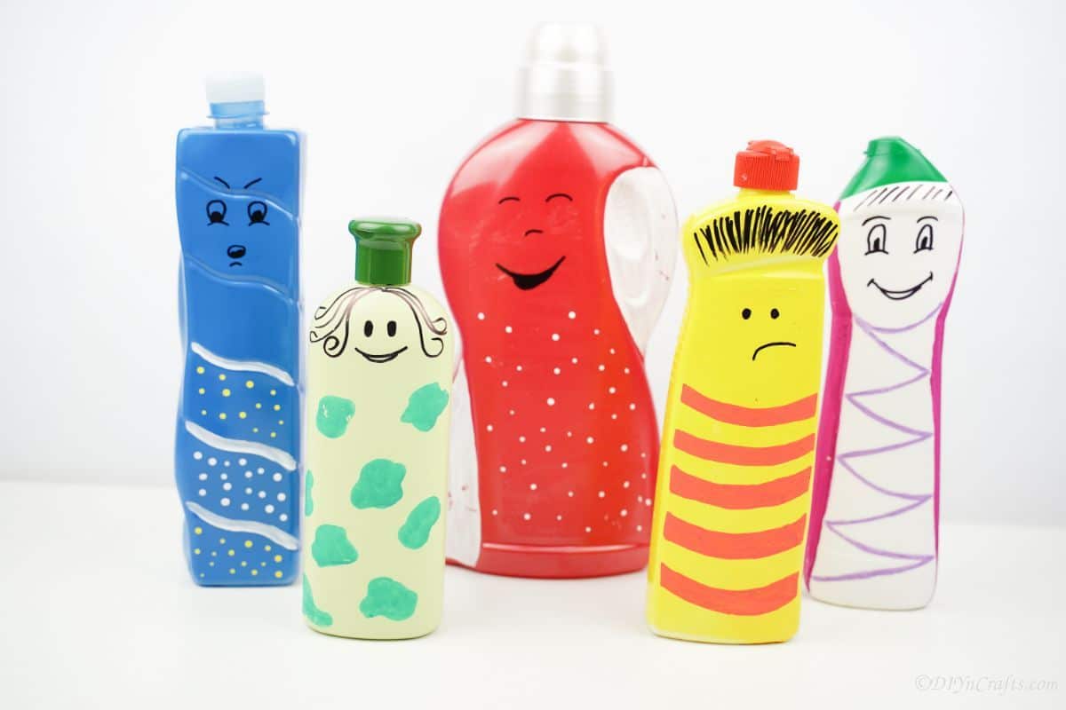 painted bottle puppets on white table