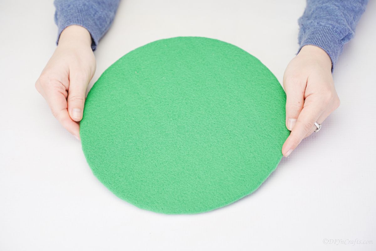 circle of cardboard covered in green felt
