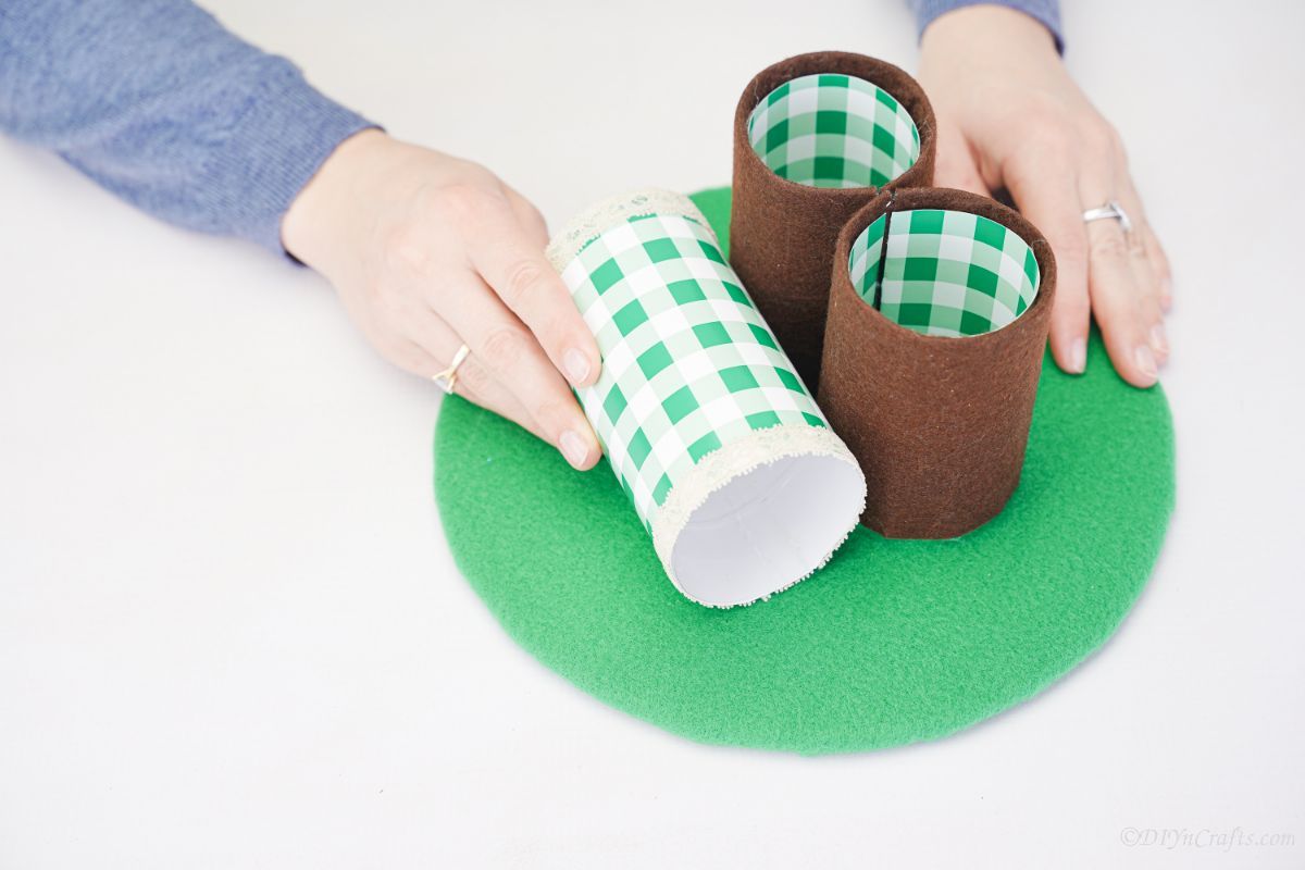 hands putting pencil holder base on green circle