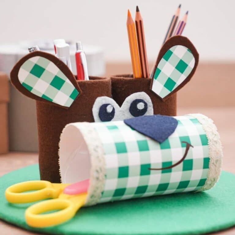greena nd brown puppy pencil holder on green mat on table