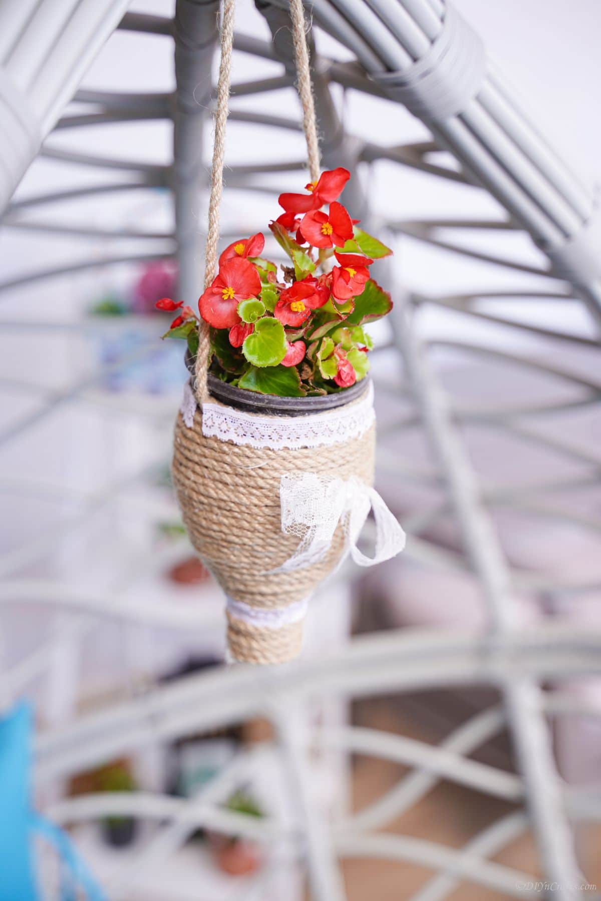 red flowers on small twine wrapped planter