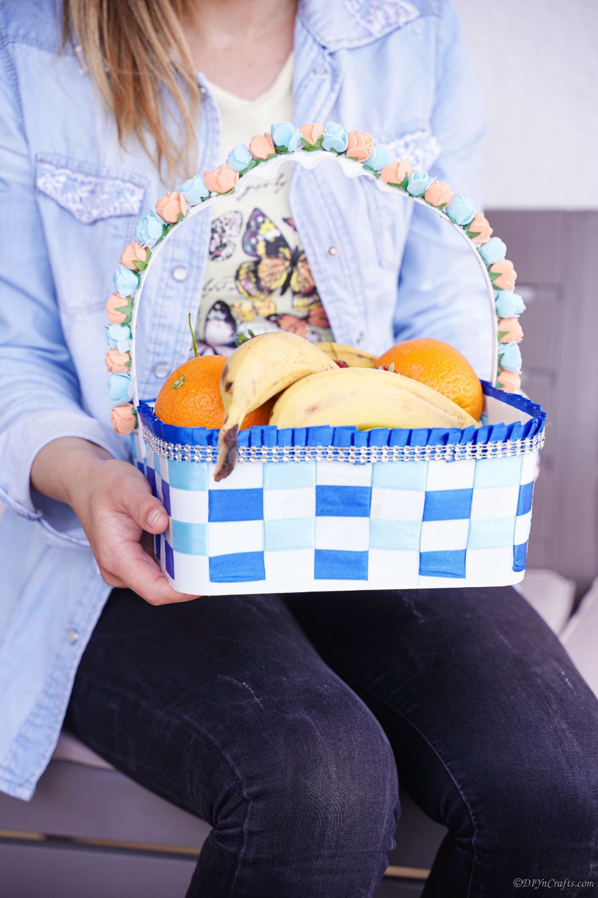 woman holding basket filled with fruit
