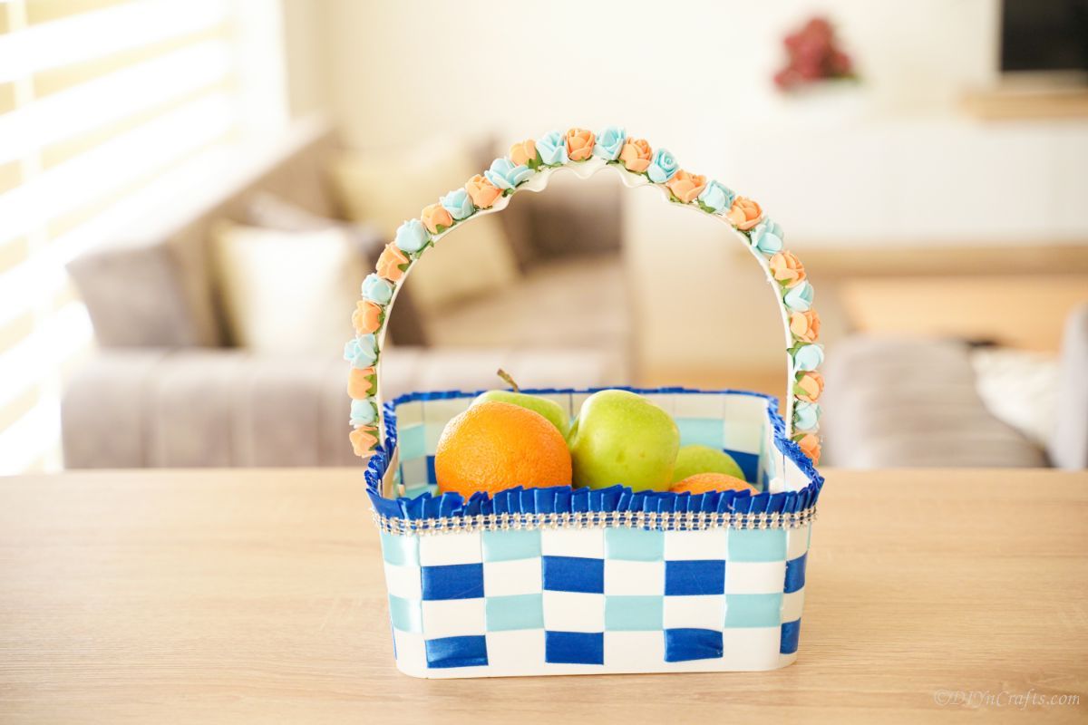 white and blue woven basket on table with fruit inside