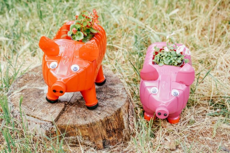 pink and red bottle pig planters on stump