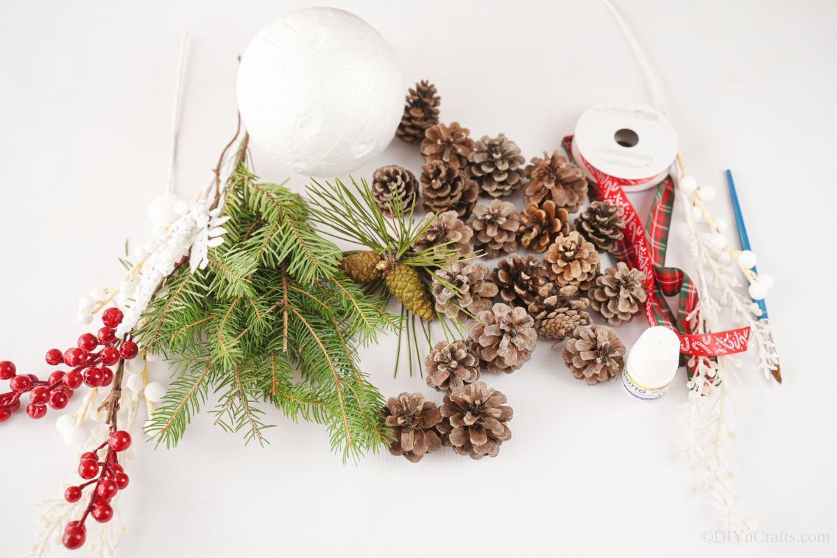 pinecones on table with ribbon and fake berries
