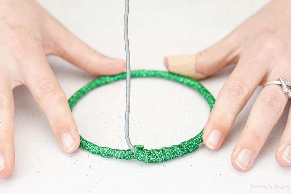 green paper on circle base of wire