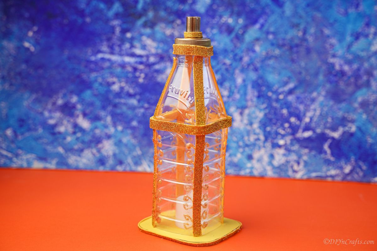 gold plastic bottle lantern on orange paper