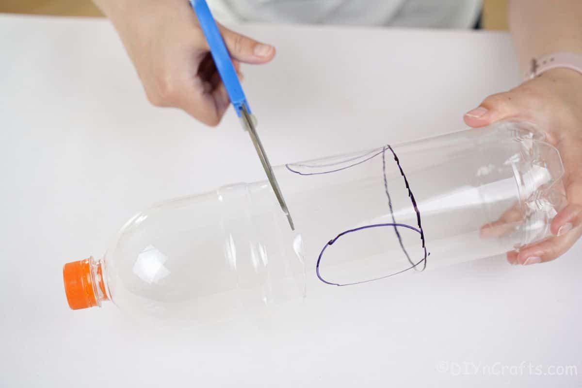 scissors cutting plastic bottle