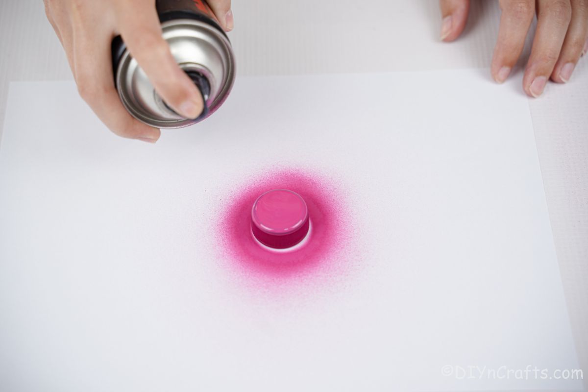 bottle cap being painted pink