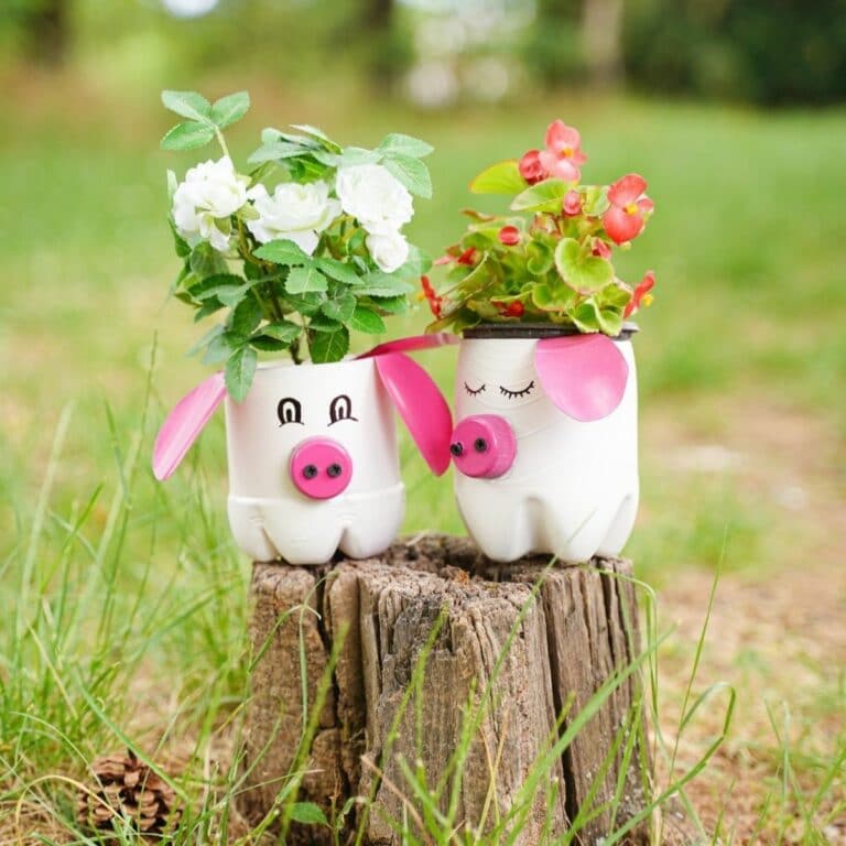 white and pink pig planters on stump