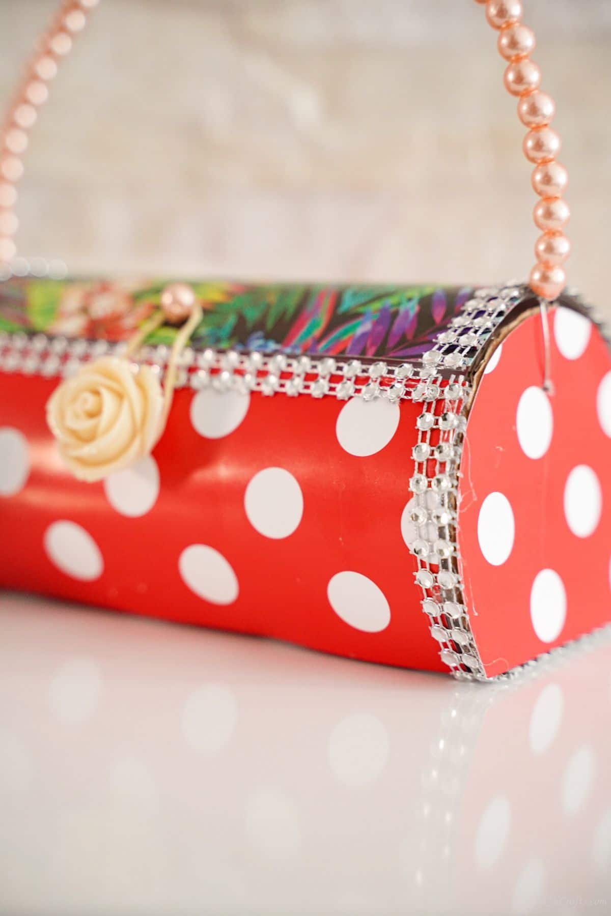 side of the plastic bottle handbag with polka dot cover and beads on edges