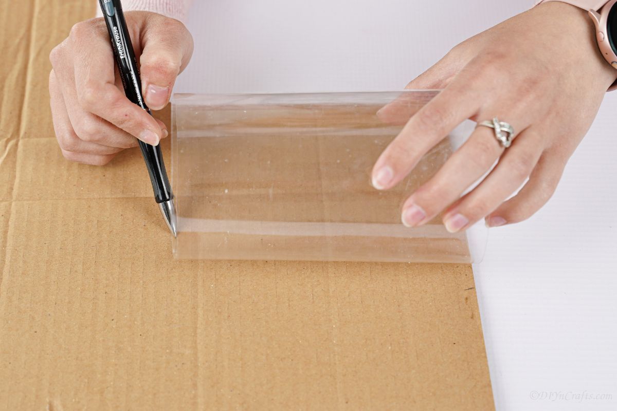 plastic being used to trace shape onto cardboard
