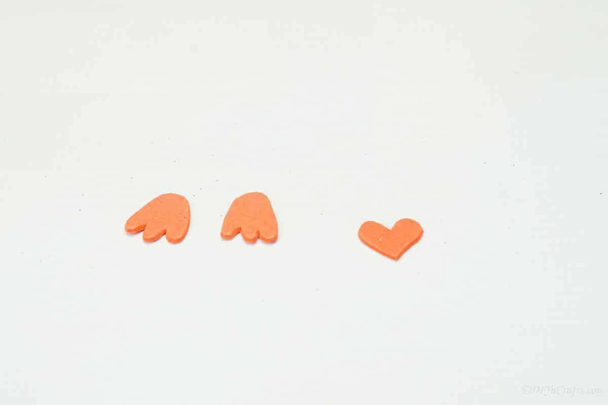 orange foam feat and heart on white table