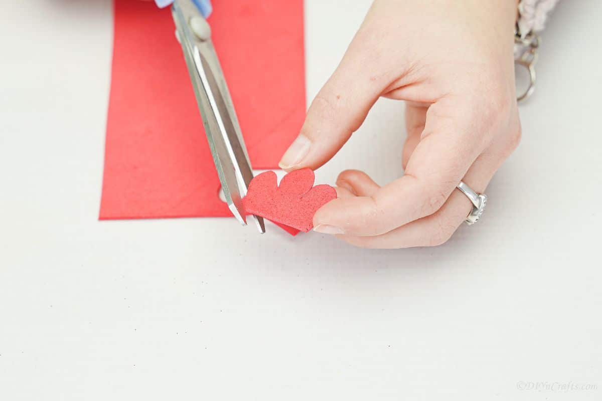 gray scissors cutting red foam paper