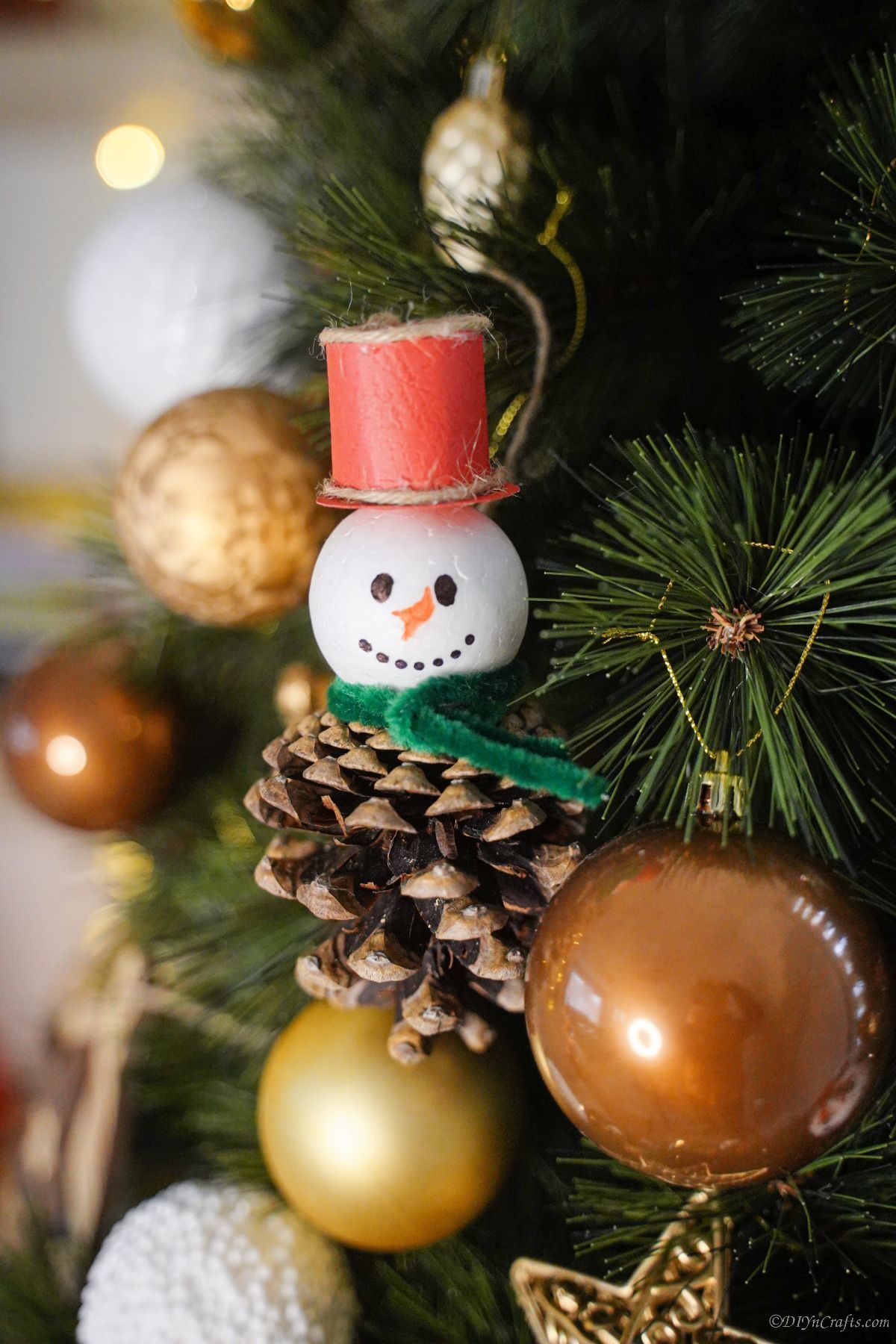 snowman ornament made of pinecone in Christmas tree