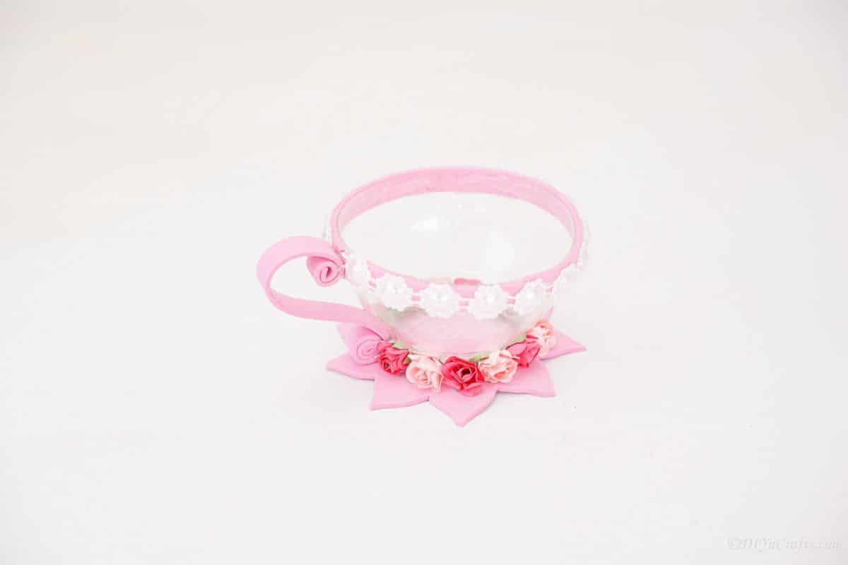 pink lined plastic bottle teacup on white table