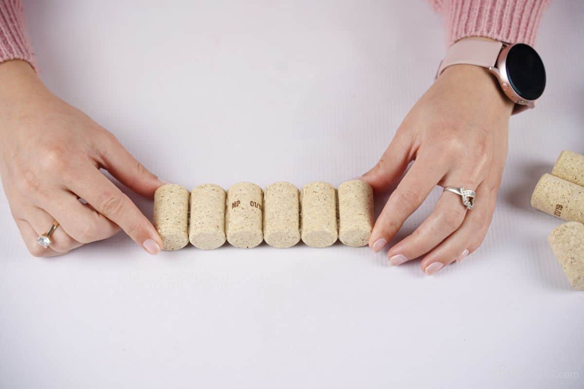gluing corks together on white table