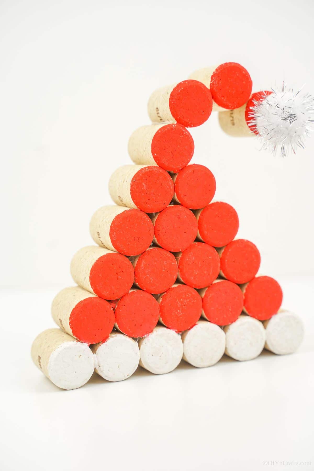 Wine cork painted santa claus hat on white table
