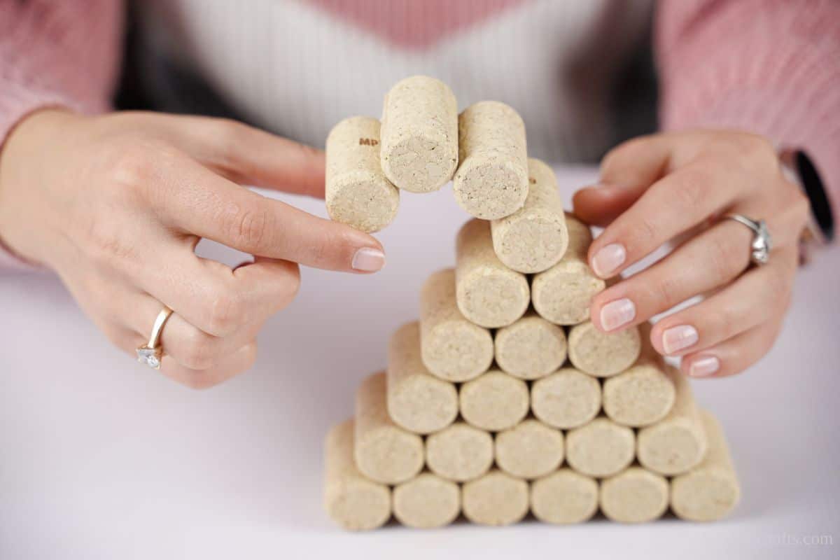 hand holding corks together as they are glued