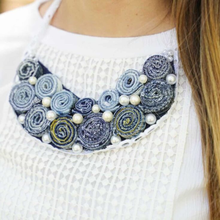 denim and lace necklace against collar of white shirt