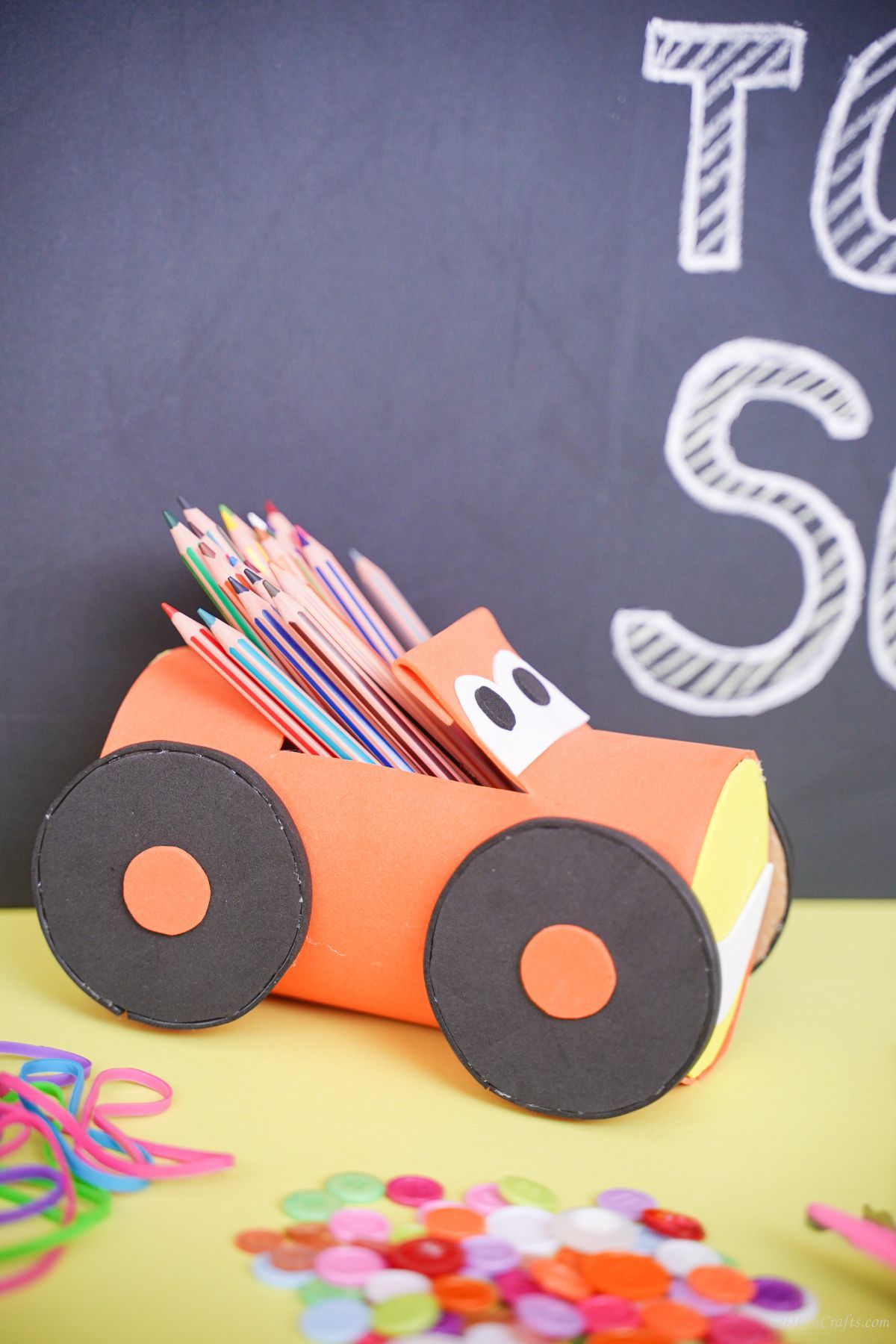 pencil holder car on yellow with chalk background
