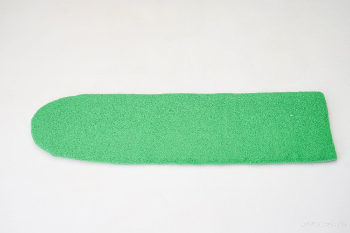 green felt covered curved piece of cardboard
