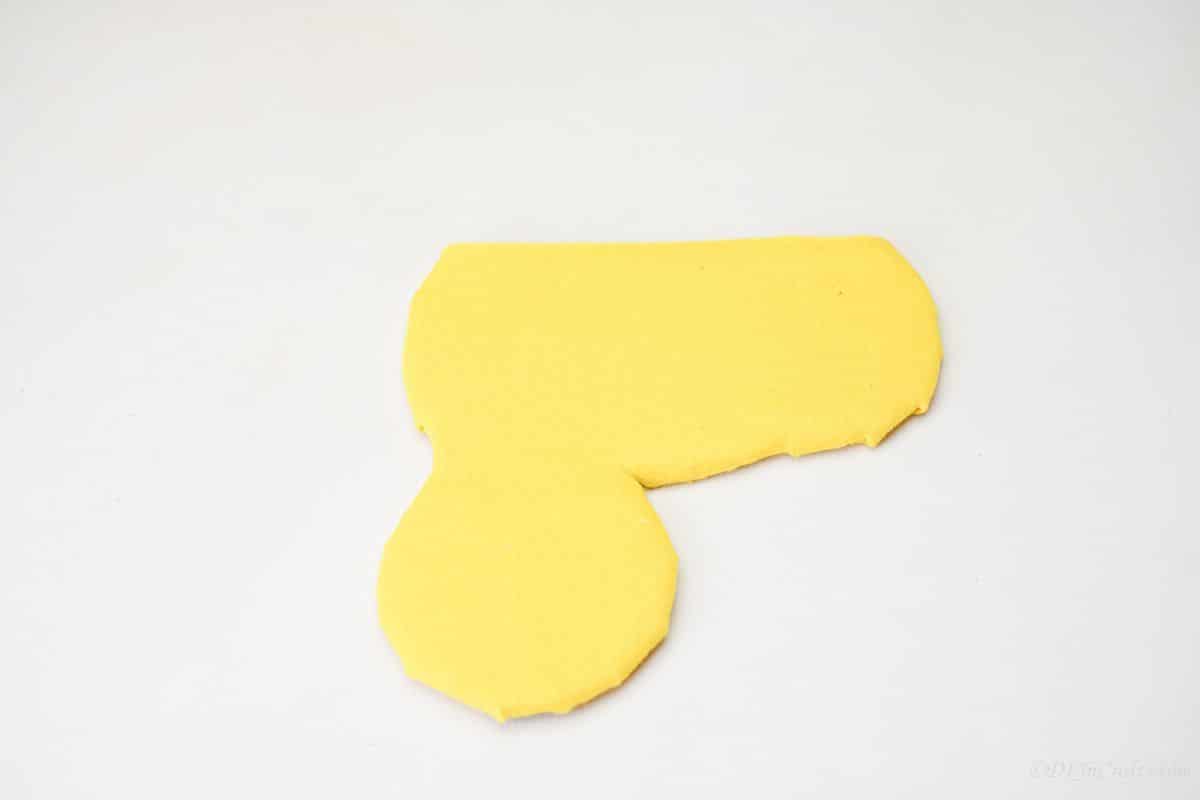 yellow covered caterpillar cardboard body on white table