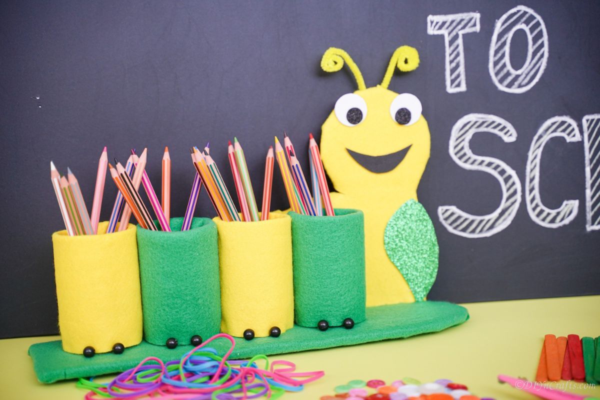 caterpillar pencil holder in front of chalkboard