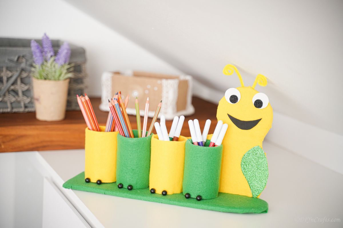 caterpillar pencil holder on white table