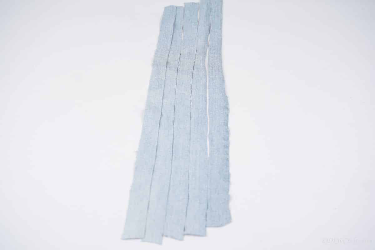 strips of denim laying on white table