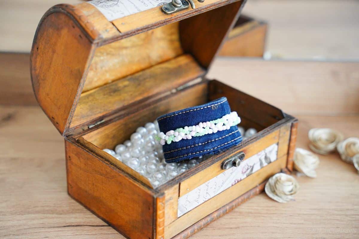 blue jean bracelet sitting on top of beads in box