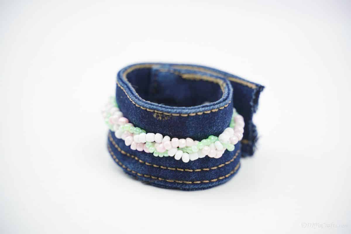 denim cuff bracelet on white table