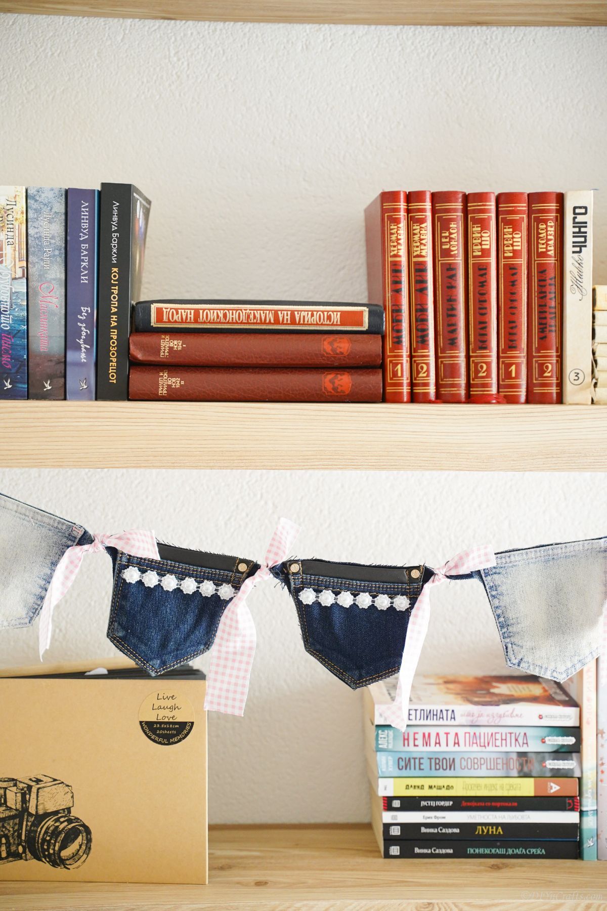 old blue jeans garland hanging in front of shelves holding books