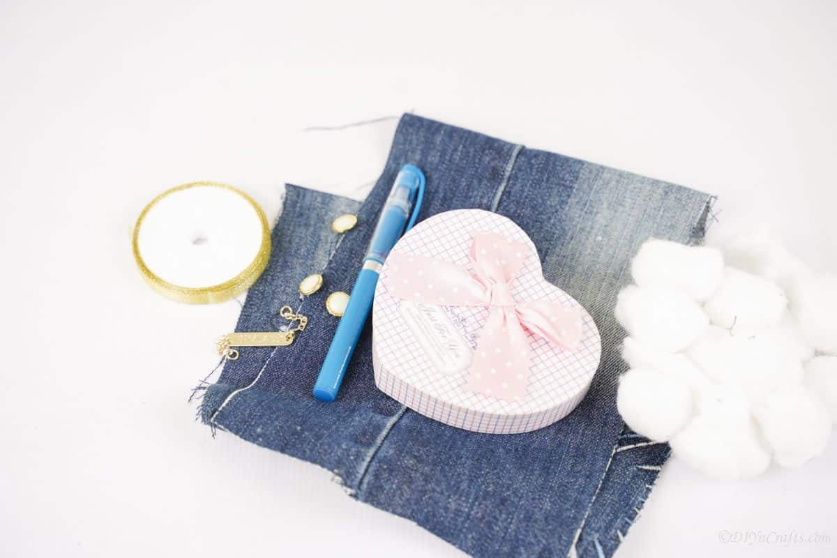 denim, lace, and a heart box on white table