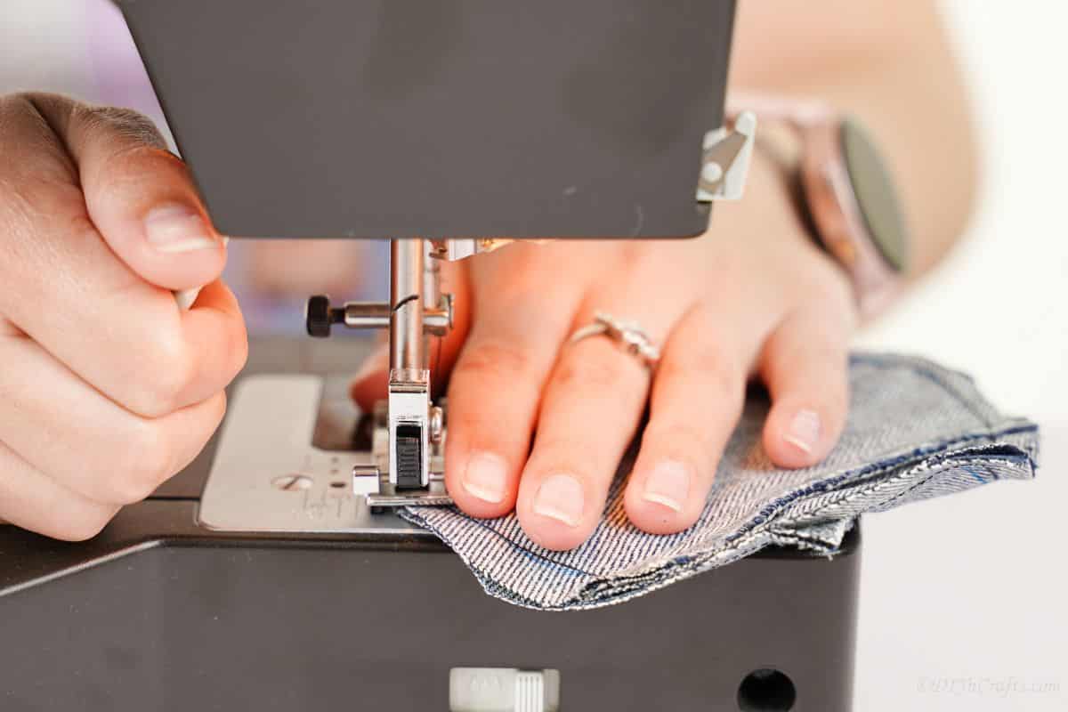 denim heart being sewn by black sewing machine