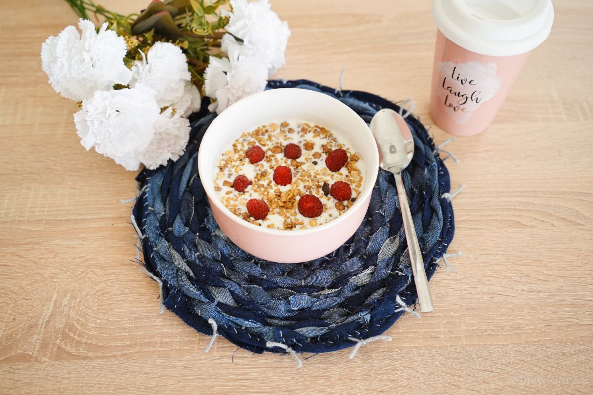 denim placemat on table with white flowers and bowl of cereal