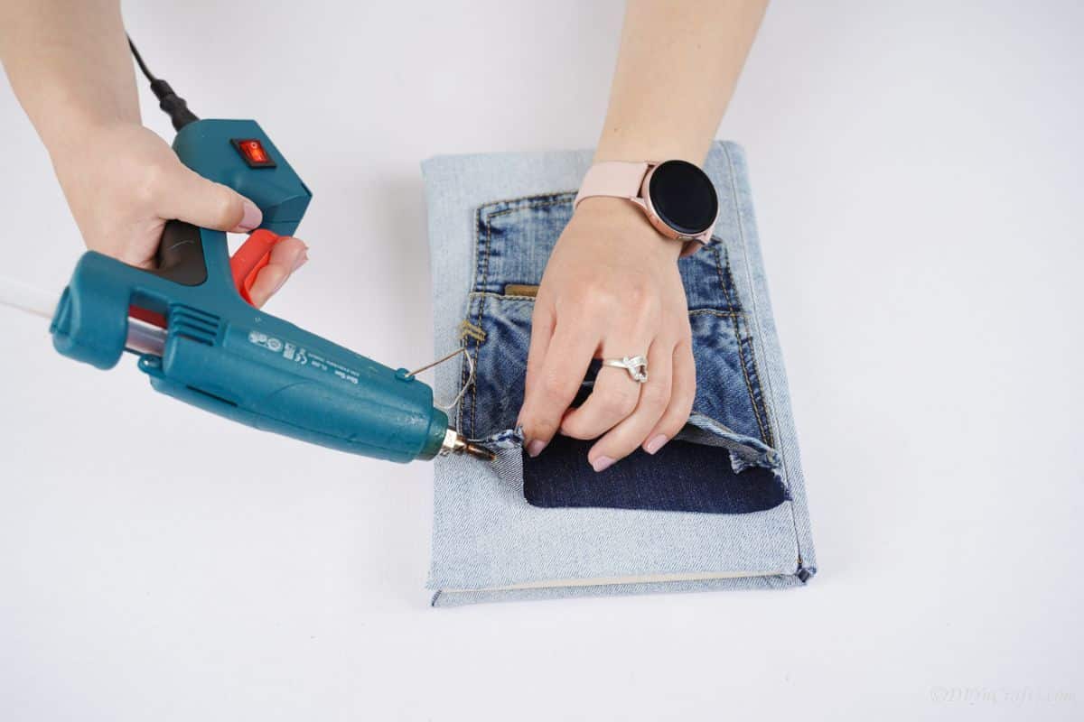 blue glue gun affixing the book pocket