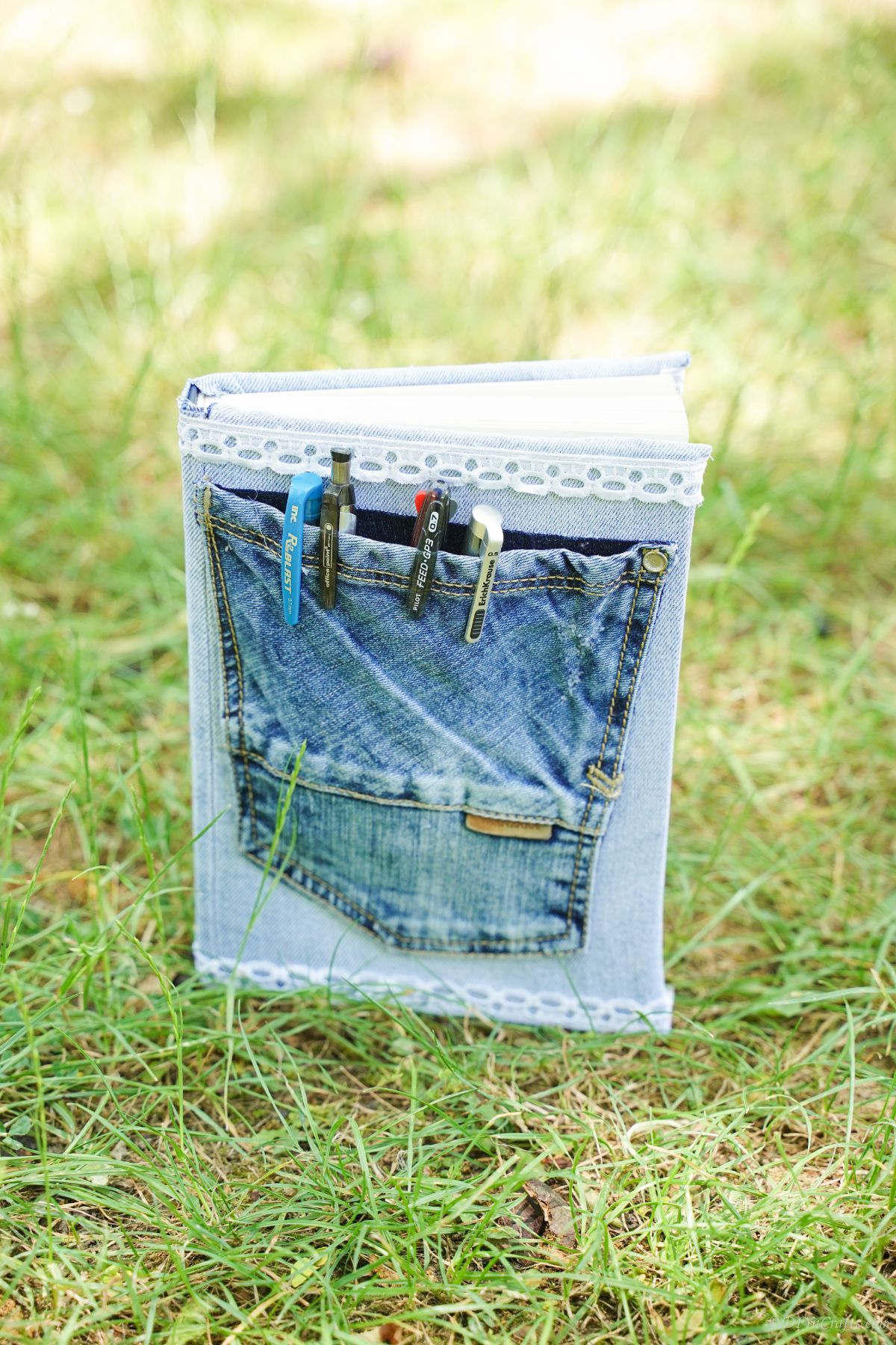 book with pocket on front sitting on grass