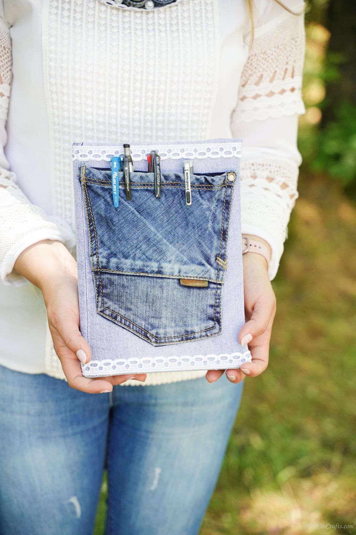 woman in white shirt holding denim pocket book cover