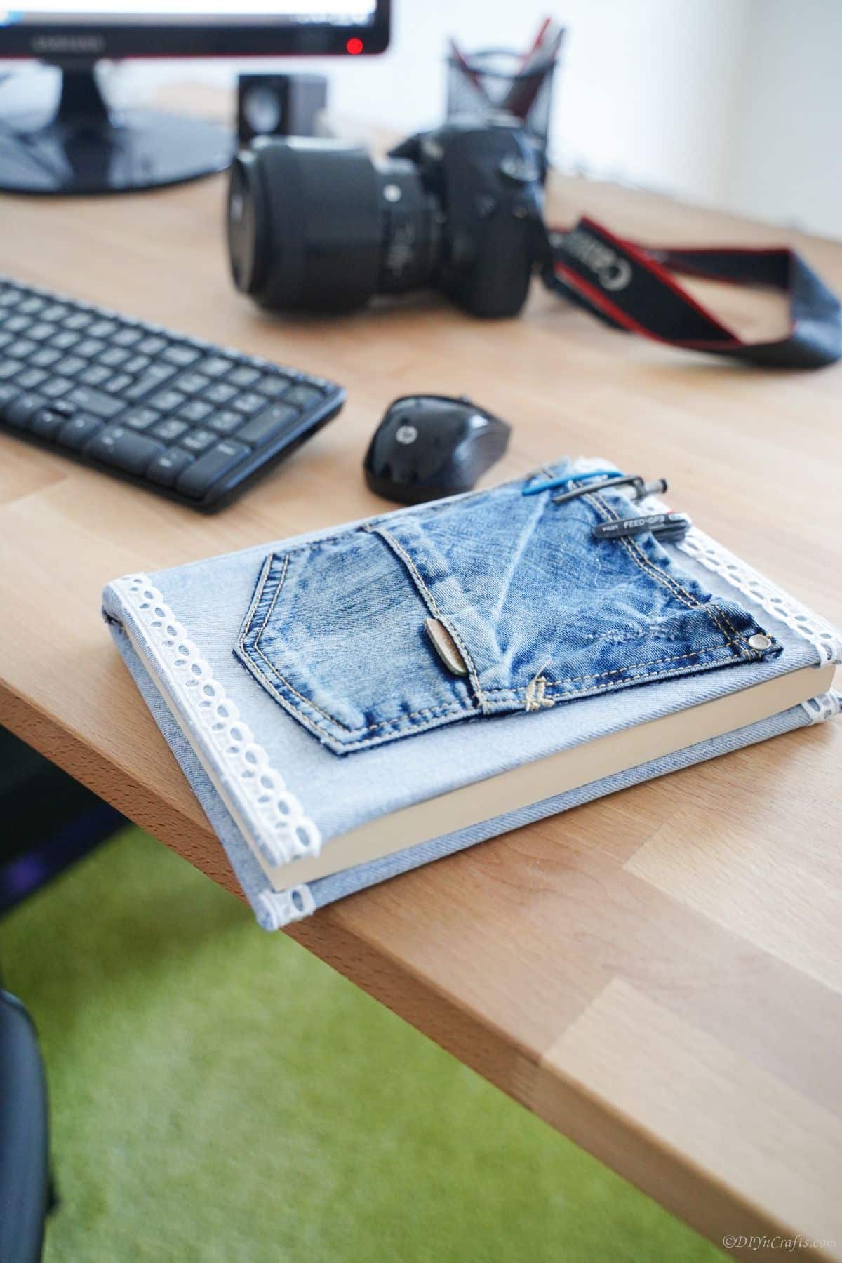 book with denim pocket on front laying on edge of desk