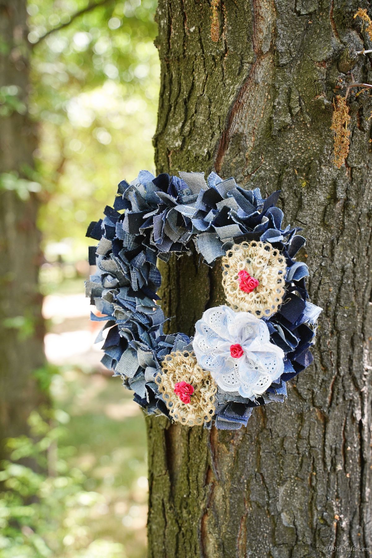 denim and lace wreath hanging on tree