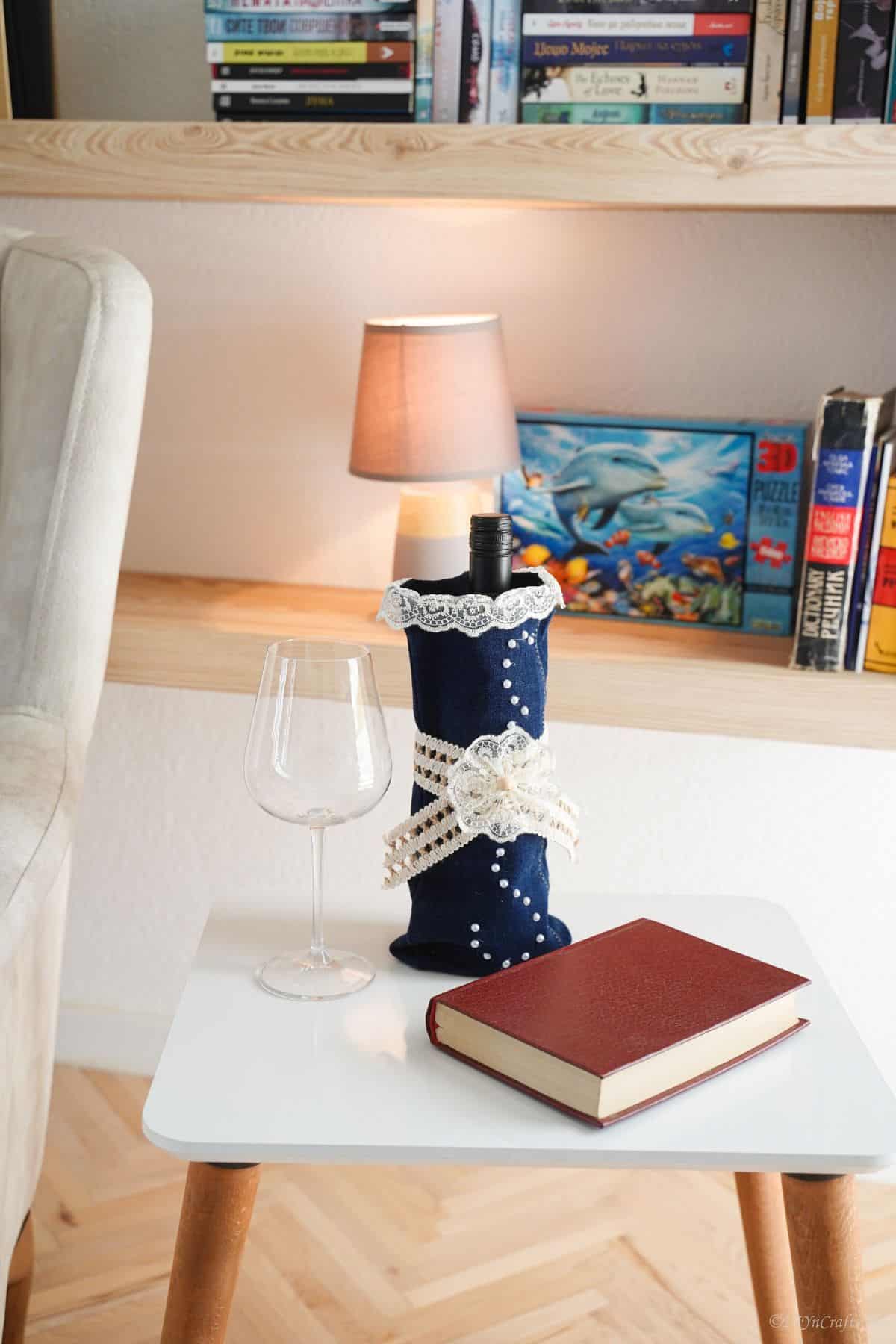 chair with white table holding wine bottle and glass