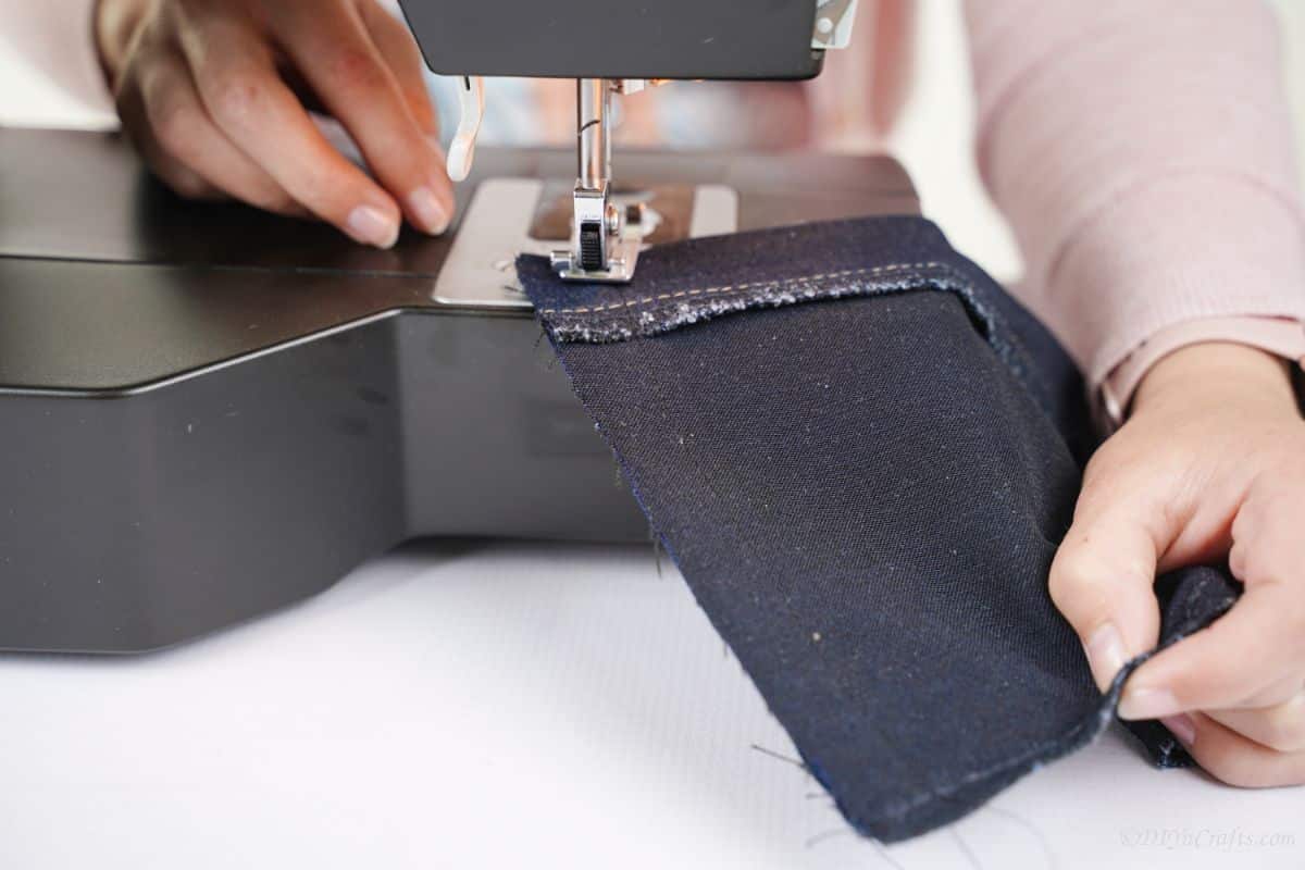 denim being sewn on sewing machine