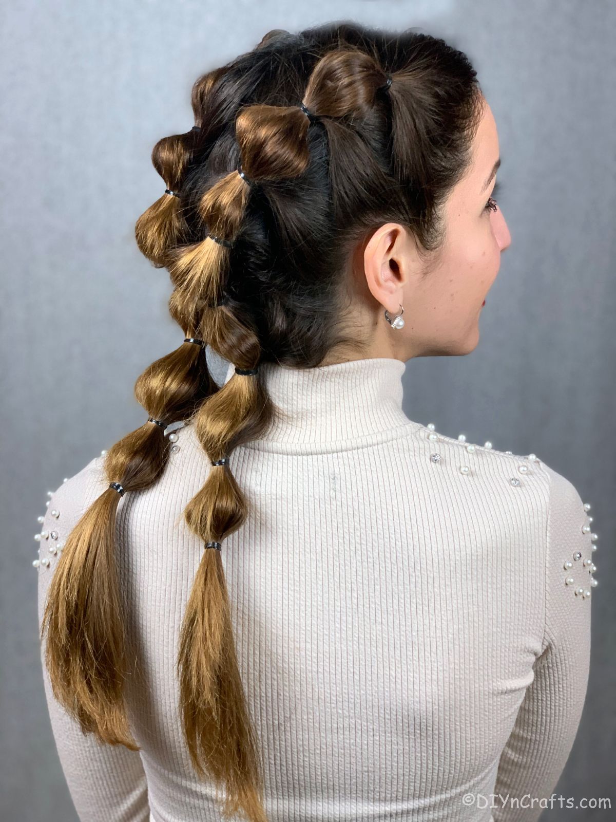 woman in white shirt with bubble braids on sides