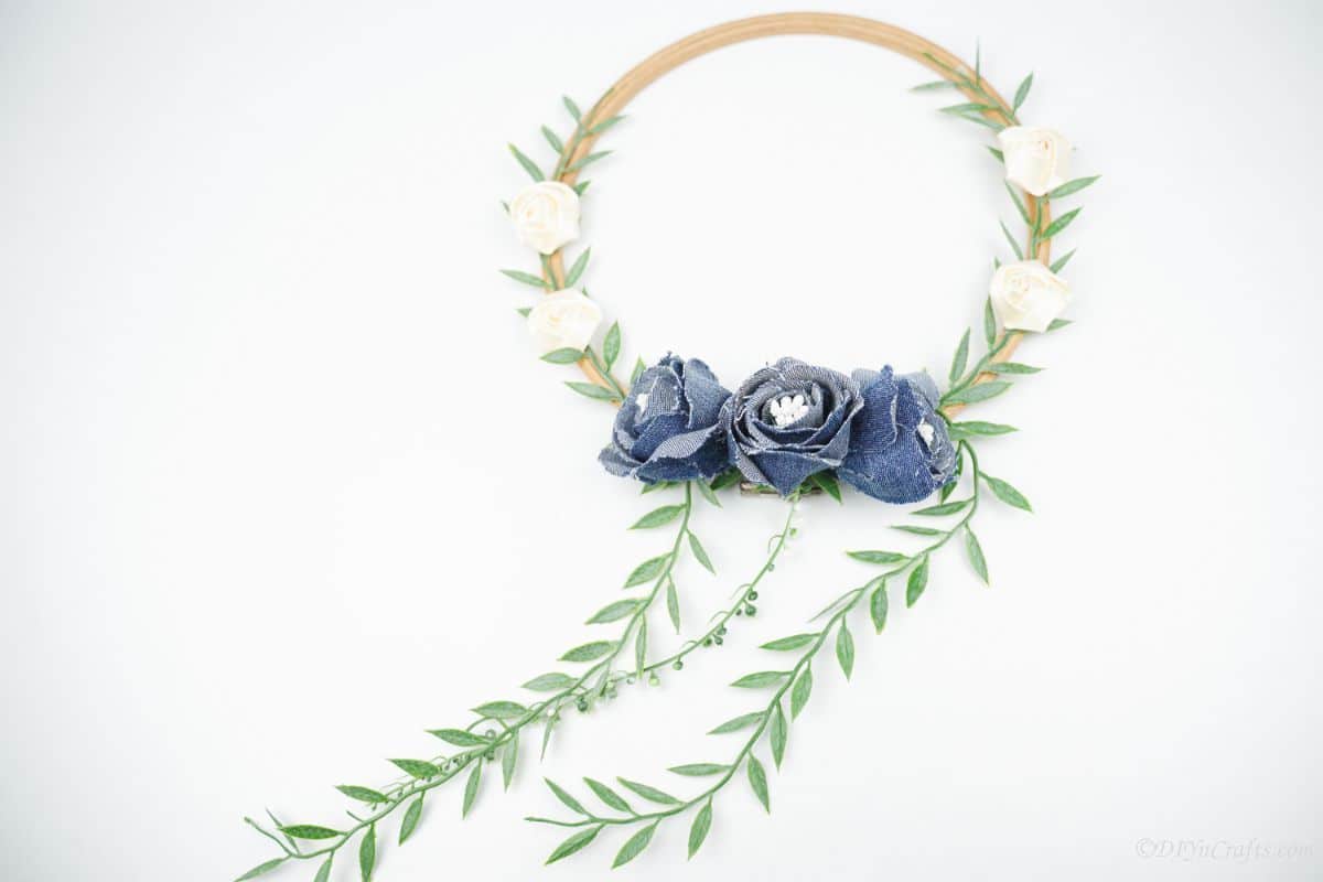 floral denim wreath laying on white table