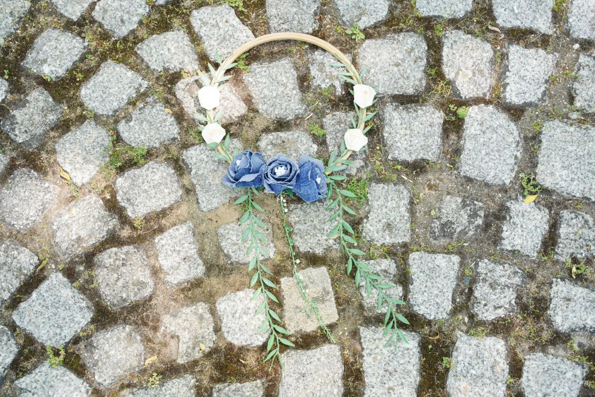 floral wreath laying on cobblestone