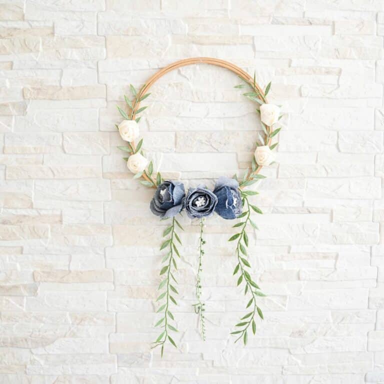 floral wreath hanging on brick wall