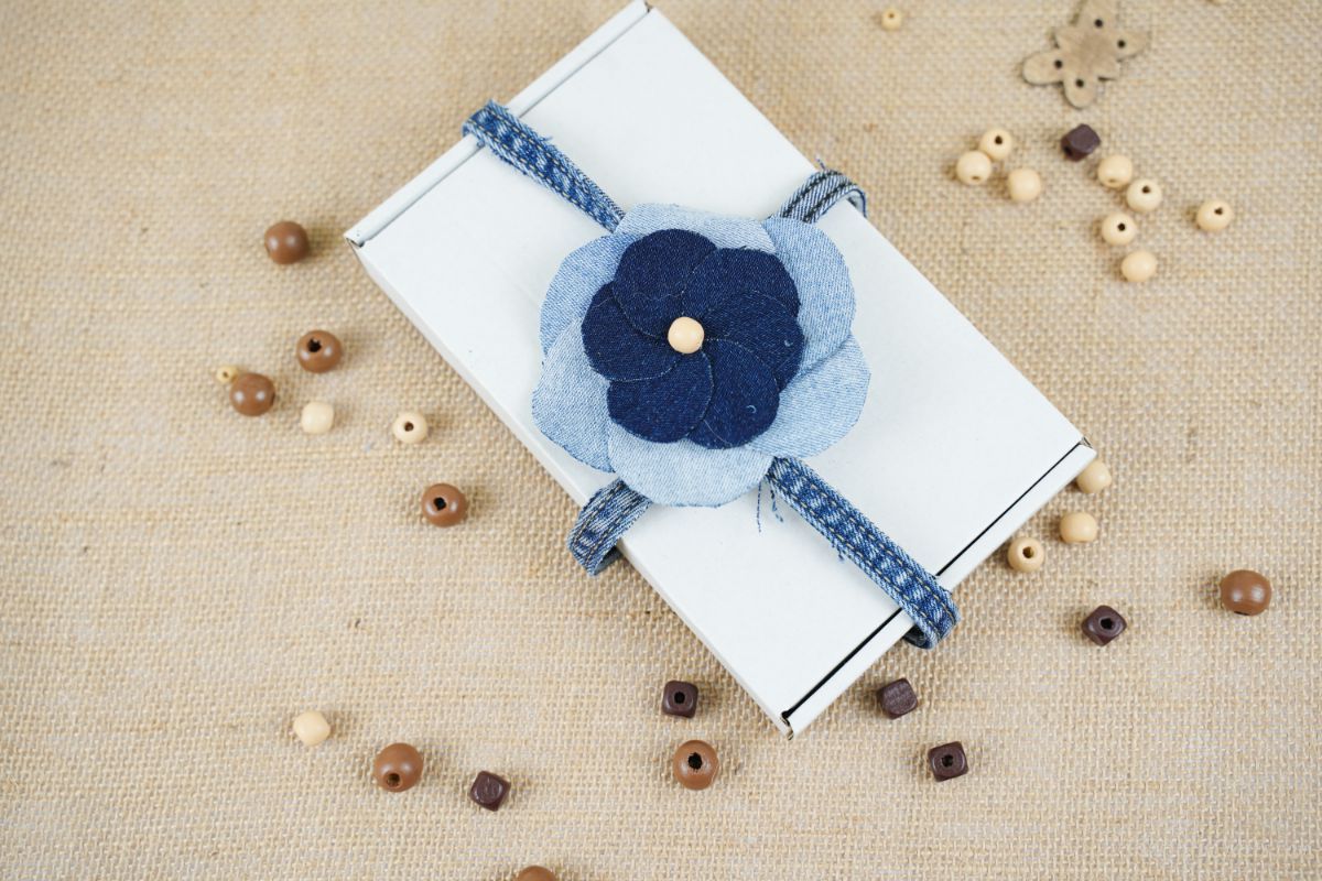 blue jean flower on top of white box on burlap